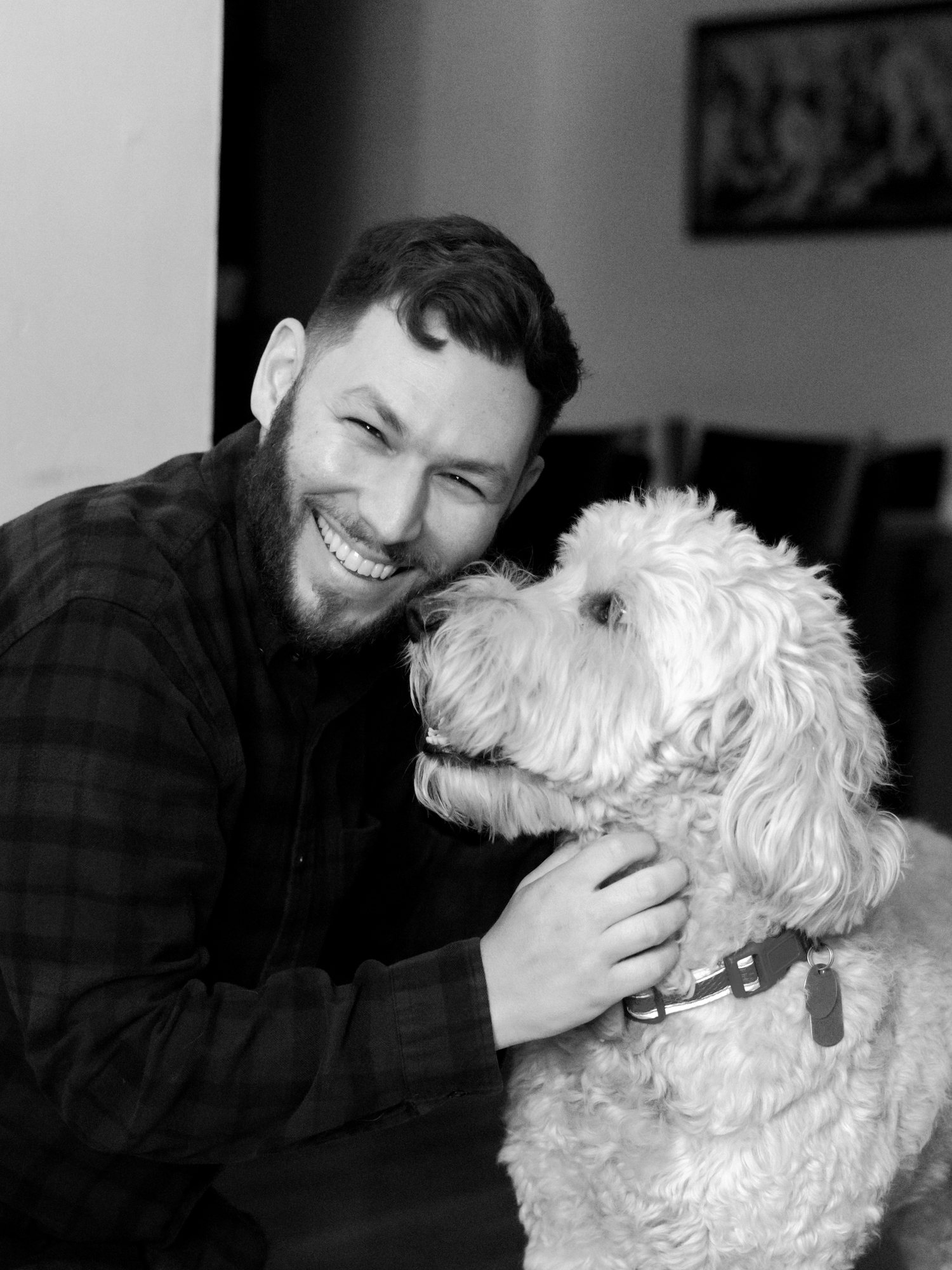 Michael James Robin smiling with his goldendoodle, Biggie Lebowski